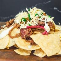 Pork Nachos · Corn tortilla chips topped with melted cheese, pico de gallo, and sour cream.