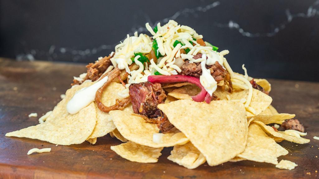 Pork Nachos · Corn tortilla chips topped with melted cheese, pico de gallo, and sour cream.