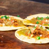 Pork Al Pastor · Slow smoked pork shoulder seasoned with various chillies and pineapple. Served with onions a...