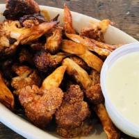 Cauliflower Buffalo Wings · Vegetarian. Cauliflower tossed with traditional buffalo wing dry spices. Choice of lemon or ...