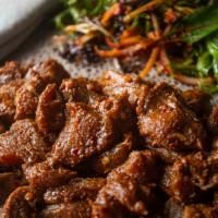 Gored Gored · Lean cubes of beef, cooked, seasoned with spices, awaze sauce, Ethiopian butter, and herbs.