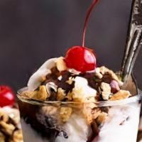 Hot Fudge Sundae · Choose your yogurt flavor 
Fudge, whipped cream, mixed nuts and cherry