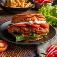 Buffalo Chicken Tender Sandwich · Golden, fried chicken tenders smothered in spicy Buffalo sauce with fresh lettuce, tomato an...