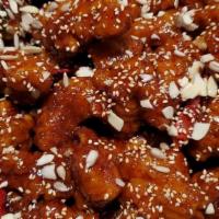 Boneless Bites Chicken · Crispy chicken bites glazed in a sticky, sweet and spicy sauce, topped with sunflower seeds,...