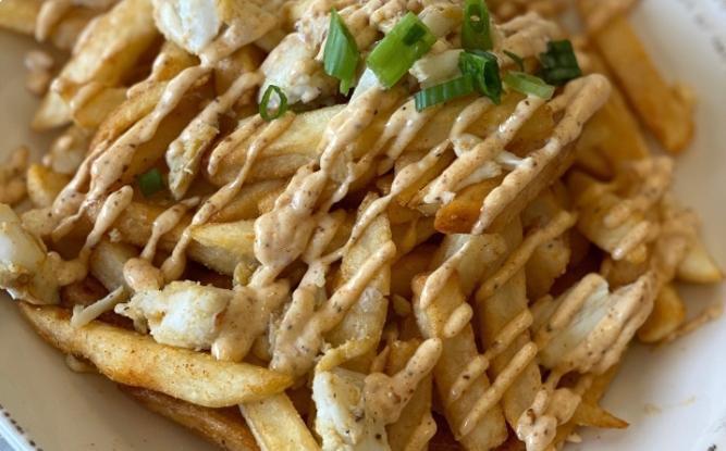 Crab Fries · Golden fries topped with jumbo lump crab and garlic aioli