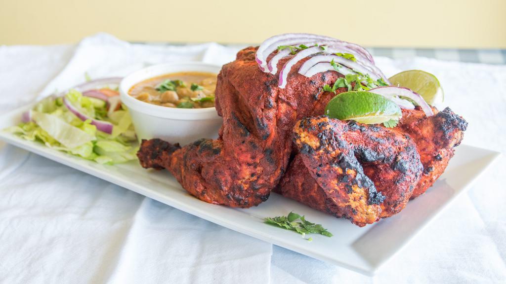 Tandoori Chicken (Half) · Chicken dish prepared by roasting chicken (marinated in special spices and herbs) in a tandoor (cylindrical clay oven).