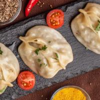 Central Asian Mantu · Lamb, onion, extra virgin olive oil, spices, salt, dough (made from scratch).