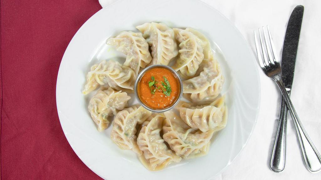 Chicken Momos (5 Pcs) · Steamed nepalese dumplings with minced chicken and nepalese spices. Served with traditional momo achar.