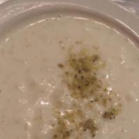 Kheer (Rice Pudding) · Long grain aromatic basmati rice cooked in milk and seasoned with cardamom. Served cold.