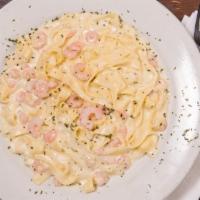 Fettuccini With Shrimp · Served with garlic bread.