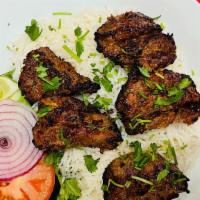 Lamb Kabob · Tender marinated lamb in house spices. Grilled and served with basmati rice, chickpeas and n...