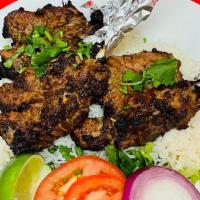 Lamb Chops · Tender marinated lamb in house spices. Grilled and served with basmati rice, chickpeas and n...