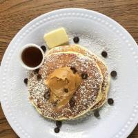 Peanut Butter-Chocolate Chip Pancakes · Two large buttermilk pancakes with peanut butter, chocolate chip cookies, syrup, and butter....
