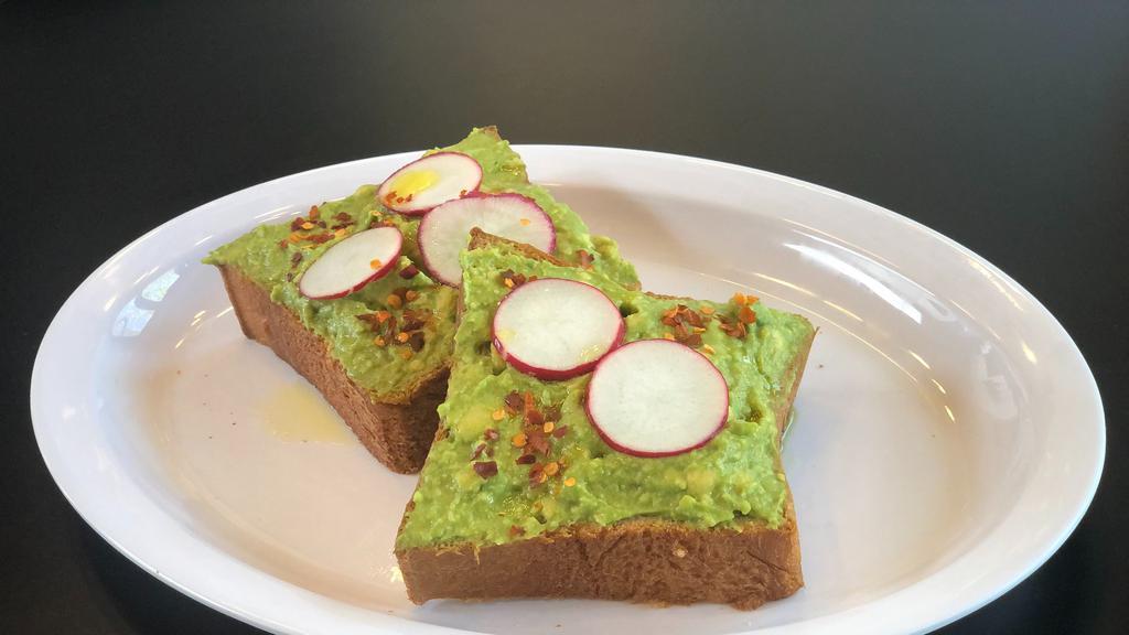 Avocado Toast · Fresh avocado on brioche topped with freshly sliced red radish, chili flakes, and light olive oil drizzle.