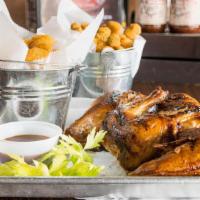 Leg & Thigh Chicken & Rib Platter · A combination of the leg and thigh accompanied with hickory-smoked ribs and finished off ove...