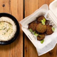 Falafel With Hummus · Deep-fried veggie balls with hummus includes white sauce and hot sauce.