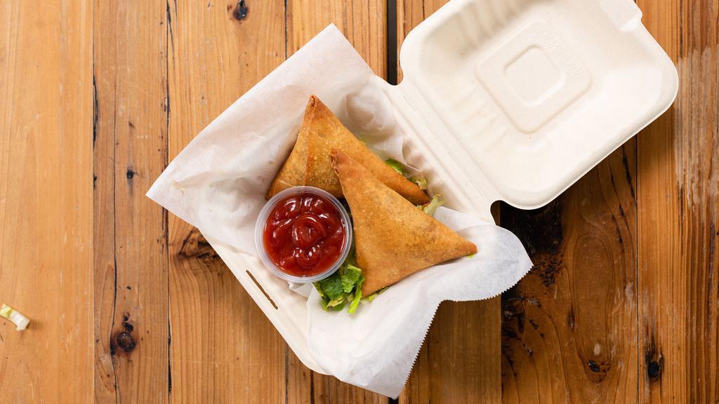 Chicken Samosas · Fried triangular pastry stuffed with chicken and spices.