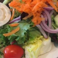 Greek Salad · Romaine lettuce, tomatoes, onions, cucumbers, Kalamata olives, stuffed grape leaves, and Fet...