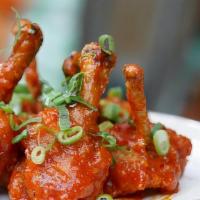 Chicken Lollipop · Chicken drumsticks marinated and coated with spicy red butter with Indian spices.