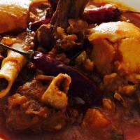 Goat Vindaloo · Goat cooked in rich spicy tangy gravy with potatoes, coconut and curry leaves.