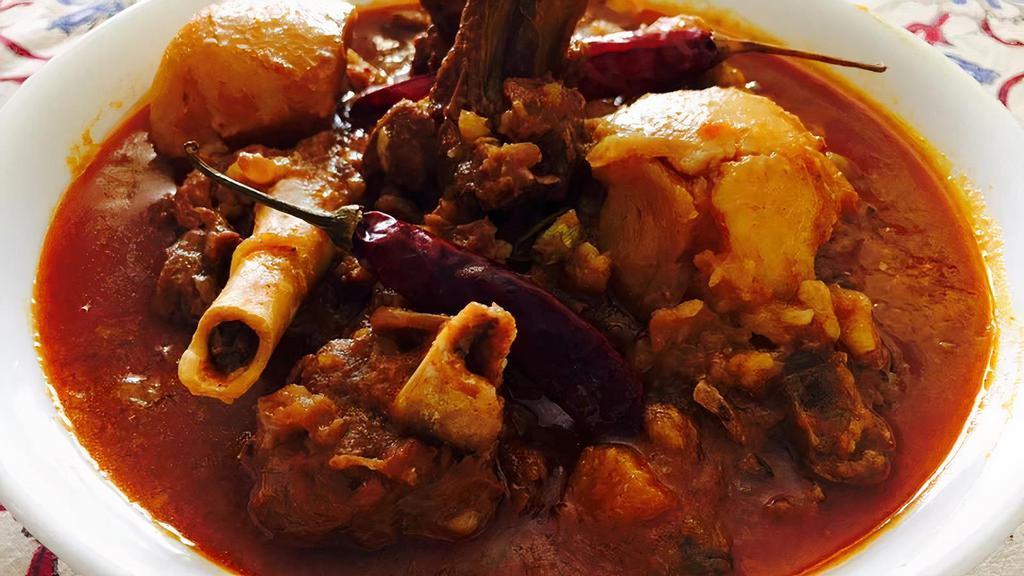 Goat Vindaloo · Goat cooked in rich spicy tangy gravy with potatoes, coconut and curry leaves.