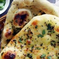 Garlic Naan · Whole wheat flour mixed with garlic,butter, milk, yogurt and cooked traditionally in clay ov...