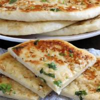 Cheese Naan · Whole wheat flour mixed with cheese, butter, milk, yogurt and cooked traditionally in clay o...