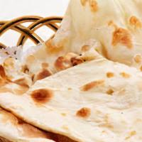 Plain Naan · Whole wheat flour mixed with milk, yogurt and cooked traditionally in clay oven.