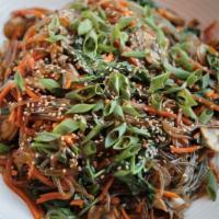 Korean Glass Noodle · Sweet potato noodles stir fried with carrots, spinach, mushrooms and green onions in a savor...