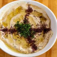 Hummus (Fatah) · Creamy hummus mixed with tahini, chickpeas, pita bread, croutons, ghee butter, fresh lemon j...