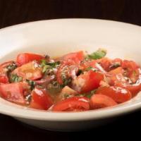 Lombardo Salad · Sicilian style tomato salad with red onions, basil, oregano, olive oil and red wine vinegar