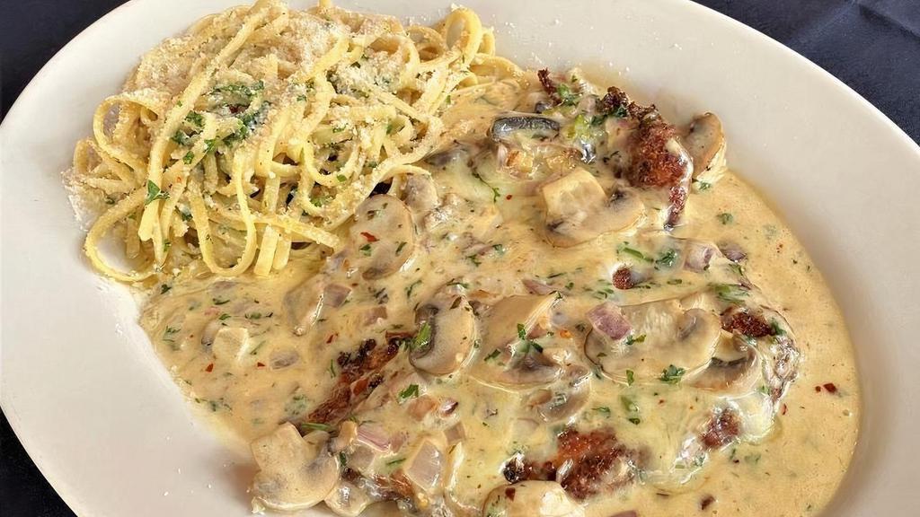 Chicken Vincenzo · Lightly breaded, crispy and topped with fontina cheese with sauteed mushrooms, garlic and onions and finished in a spicy cognac cream reduction. Served with linguine in olive oil and garlic