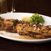 Garozzo · Marinated chicken breast rolled in Italian bread crumbs skewered broiled.  Served in amogio,...