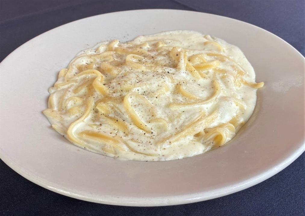 Fettuccine Alfredo · Fettuccine pasta served in a creamy Alfredo sauce