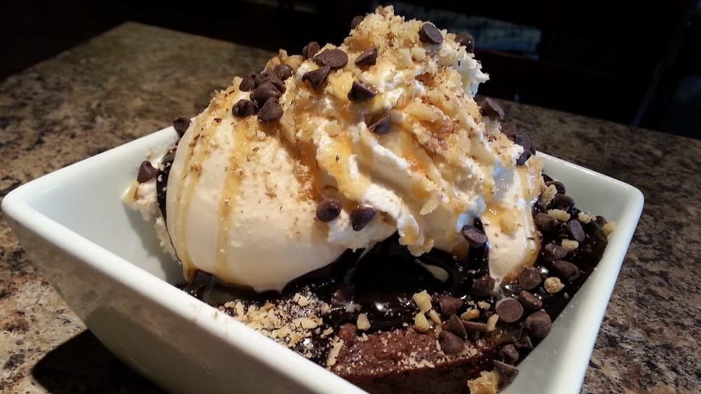 Botticelli Brownie Sundae · Our famous chewy chocolaty fudge brownie is topped with Honey Vanilla ice
cream, and smothered with hot fudge, caramel, whipped cream,
chocolate chips, and nuts. Simply divine.