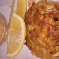 Crab Cake · One jumbo lump crab cake served with lemon wedges and a chipotle aioli sauce.