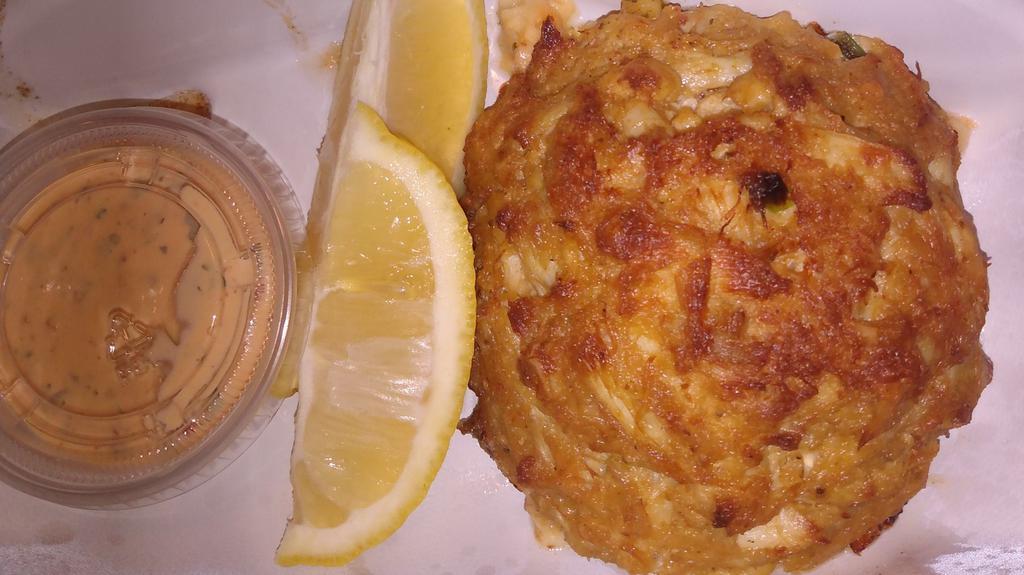 Crab Cake · One jumbo lump crab cake served with lemon wedges and a chipotle aioli sauce.
