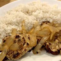 Pollo A La Plancha · Boneless chicken breast marinated in lemon and garlic, grilled and smothered with onions. Se...