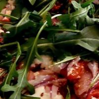 Pancetta · Fresh mozzarella, goat cheese, pancetta, red onions, roasted red peppers and arugula
