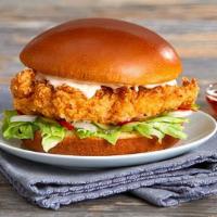 Fried Chicken Burger · Crisp chicken breast, chipotle mayonnaise, lettuce, white onions, and dill pickle served on ...
