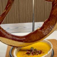 Giant Bavarian Pretzel · Served with homemade house beer grain mustard, with or without salt. (Pictured with queso)