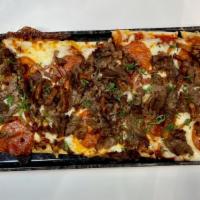 Meat Lovers Flatbread · Fresh tomato sauce topped with mozzarella and loaded with steak, bacon and pepperoni on Doyl...