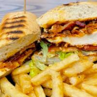Buffalo Fried Chicken Panini · Crispy fried chicken tossed in buffalo sauce with bacon, shredded lettuce, tomato and ranch ...