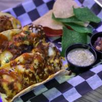 Brayden'S Fire Tacos · Three corn tortillas, jumbo fried tenders tossed in Kevins' Homemade Fire sauce, tossed with...