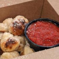 Garlic Knots · Tossed in butter, fresh garlic, and herbs, parmesan cheese, served with a side of tomato sau...
