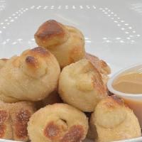 Cinnamon Sugar Knots · Buttered knots tossed in cinnamon sugar and served with a side of brown butter caramel sauce...