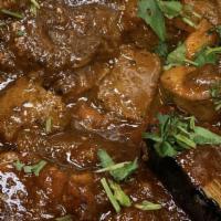 Lamb Curry · Boneless cubes of lamb cooked in a rich tomato curry.