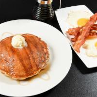 Pancakes Deluxe · Customer favorite. Served with your choice of ham, sizzling bacon, or sausage along with two...