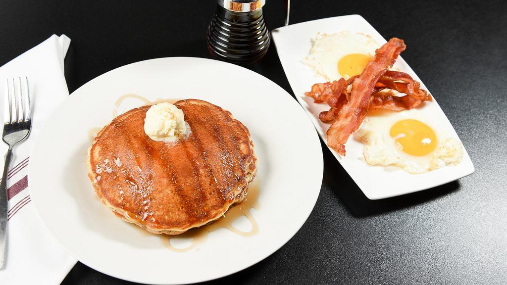 Pancakes Deluxe · Customer favorite. Served with your choice of ham, sizzling bacon, or sausage along with two eggs, any style.