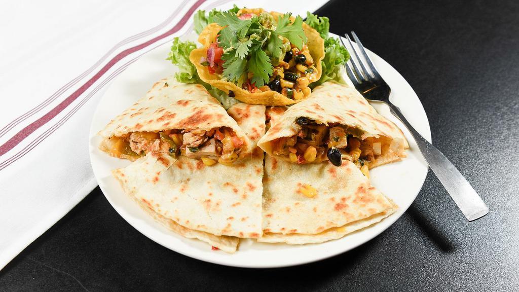 Chicken Fajita Quesadilla · Your choice of chicken or beef, with peppers, onions, and cheddar cheese, served with sour cream, guacamole, pico de gallo, and black bean and corn salsa.